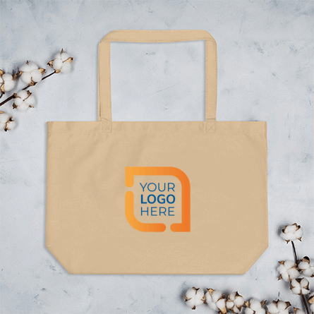Custom canvas tote bag laying on background with a sample logo on the front