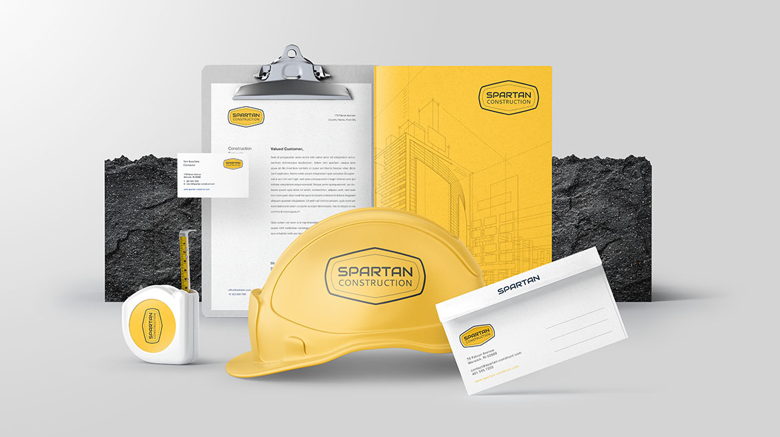 Spartan Construction logo created using Logo Maker for a construction company, used in branded equipment, yellow safety helmets, business cards and more